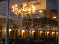 Front window of the hair salon with the chandelier Beauty Collective Hair Salon in Birmingham, Michigan.